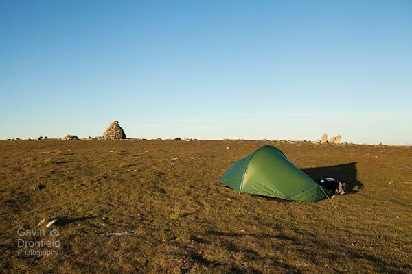 terra nova competition tent pitched near summit cairn on brim fell at sunset