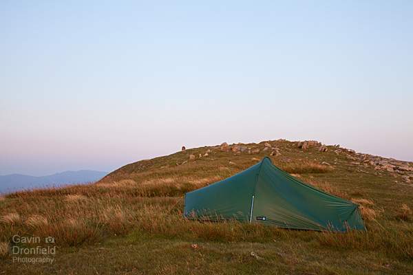 tent pitched on dale head summit ridge at red summer dusk