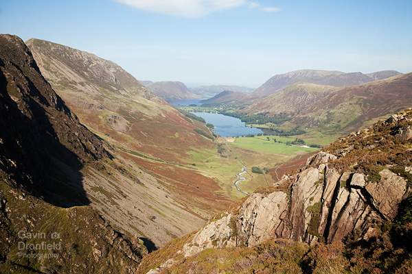 buttermere lake in the buttermere valley under blue skies seen from green crag