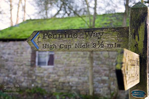 wooden pennine way finger post in dufton pointing to high cup nick