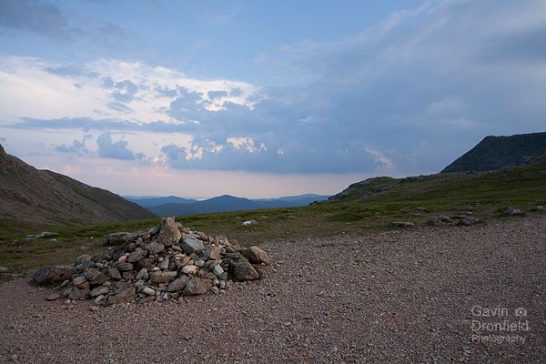 stone cairn at esk hause under dark foreboding skies at dusk