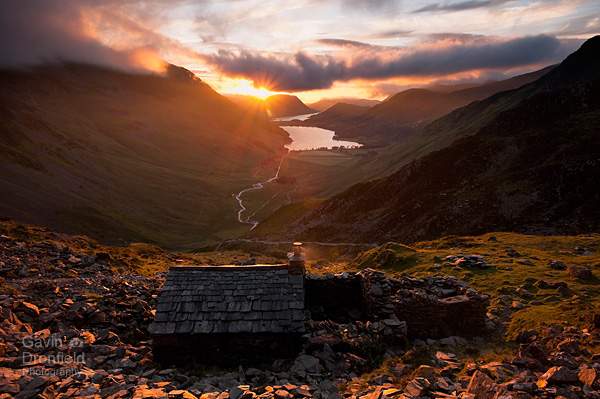 warnscale bothy view of buttermere and crummock water in almospheric red evening light as sun sets behind mellbreak