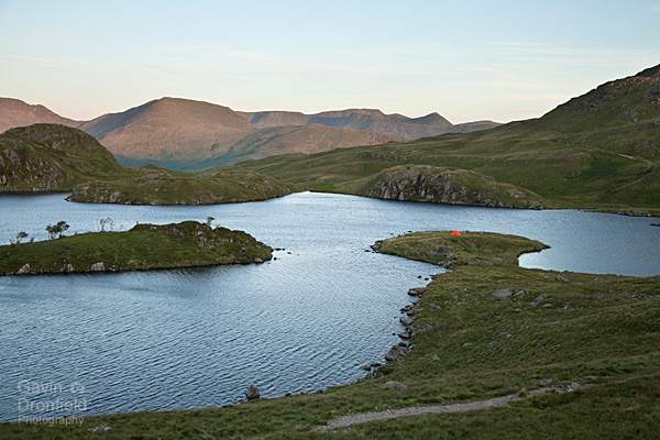 tents on the shore of angle tarn with backdrop of helvellyn at dawn