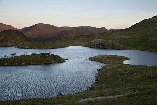 tents on the shore of angle tarn with backdrop of helvellyn at dawn