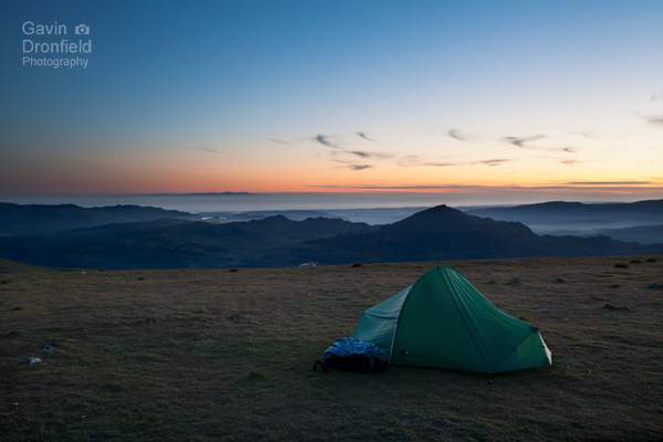 terra nove competition tent wild camping on brim fell with atmospheric summer nighttime view of green crag and isle of man at sunset