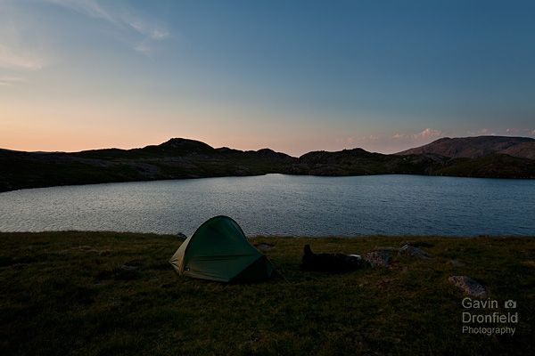 terra nova tent pitched at sprinkling tarn at dusk