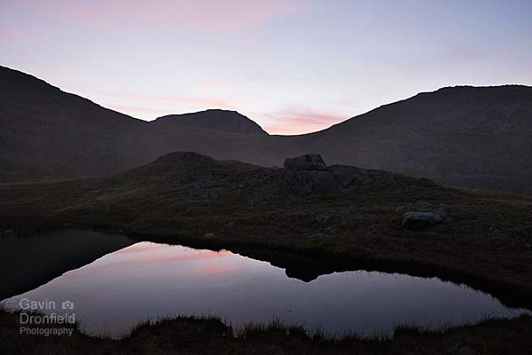 misty monochrome view from unnamed tarn on tongue head in dwindling light of dusk