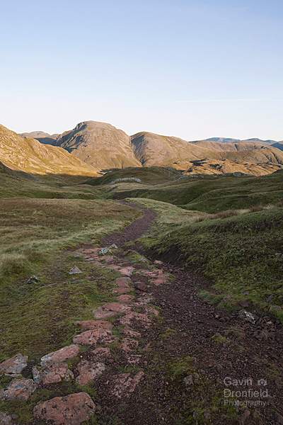 paved footpath from esk hause down to styhead pass with great gable and green gable in profile on skyline