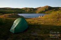 wild camping tent pitched on shore of blea tarn under bleatarn hill