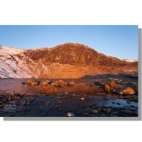 Pavey Ark and Stickle Tarn at dawn in winter