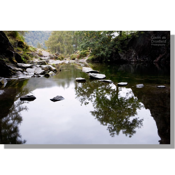 reflection in Rydal Cave pool with stepping stones