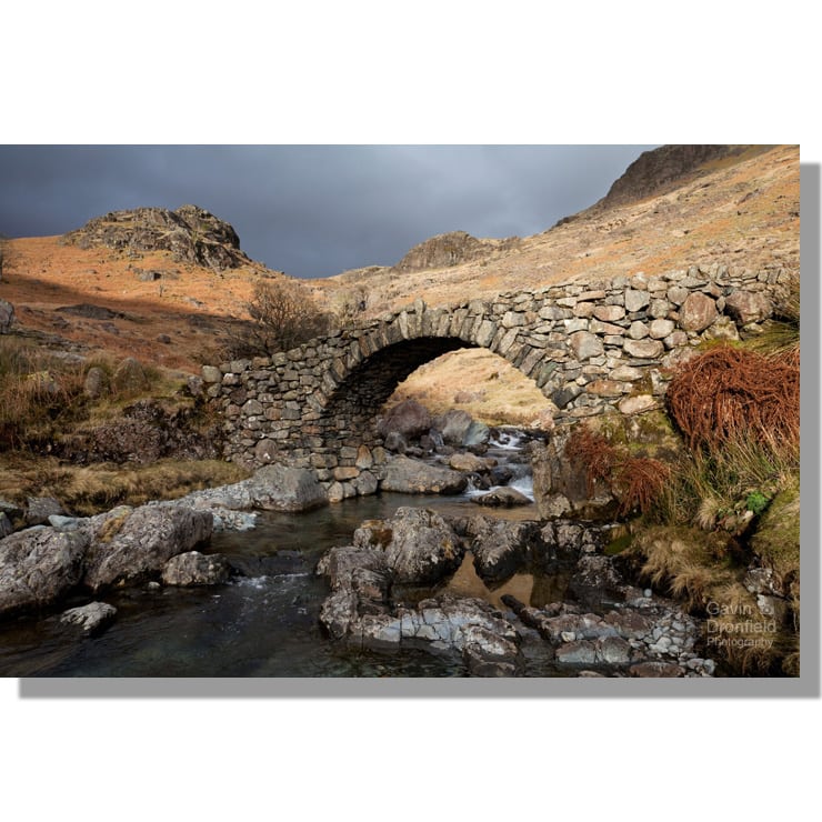 ancient stone packhorse bridge of lingcove bridge over lingcove beck surrounded by winter hues