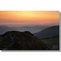 red orange atmospheric summer sunset from dale head ridge path looking over loweswater fells