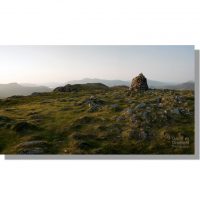 panoramic view from cairn on high spy summit at sunset under clear skies looking towards distant skiddaw