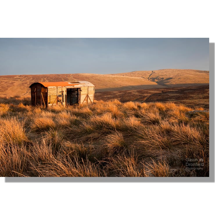 dilapidated railway wagon on grassy birkdale common at sunset with great shunner fell in background