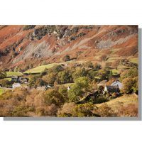 cottages of little langdale village at the foot of lingmoor fell hidden by colourful autumnal trees