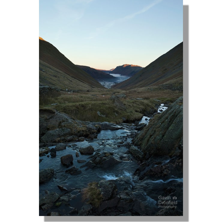 kirkstone beck flowing down kirkstone pass towards misty patterdale valley as place fell glows red in rising sun