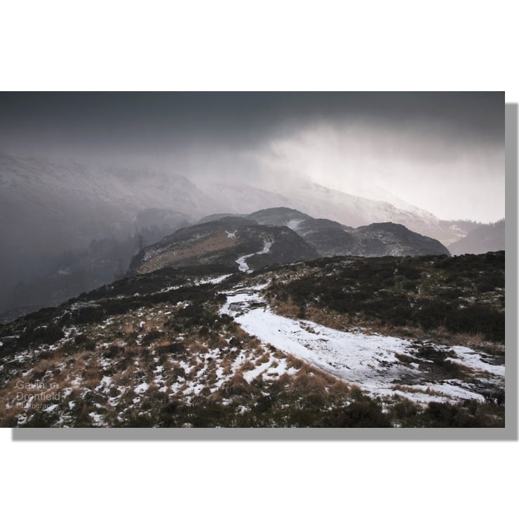 high rigg summit footpath in a hailstorm under ominous dark storm clouds